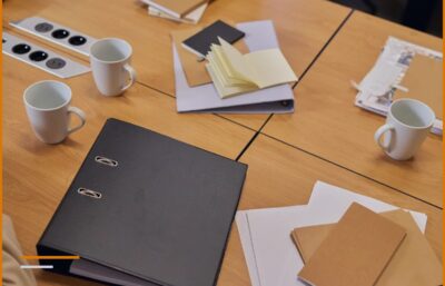 Tavolo da riunione con fascicoli, cartelle e documenti: inizio della collaborazione con un nuovo cliente.