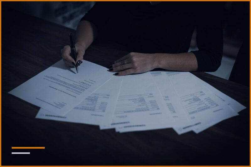 Inheritance and gift tax, hands signing documents on a table.